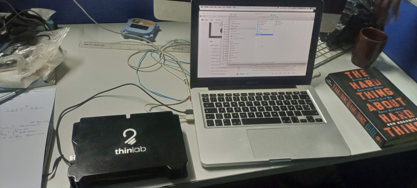ChungaBox connected by USB to a laptop on a desk, ready to power a shared classroom workstation.